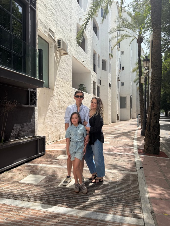Iskender, his wife and their daughter Taira on a sunny street